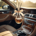 DreamWeaver glass diffuser bottle hanging from car rearview mirror